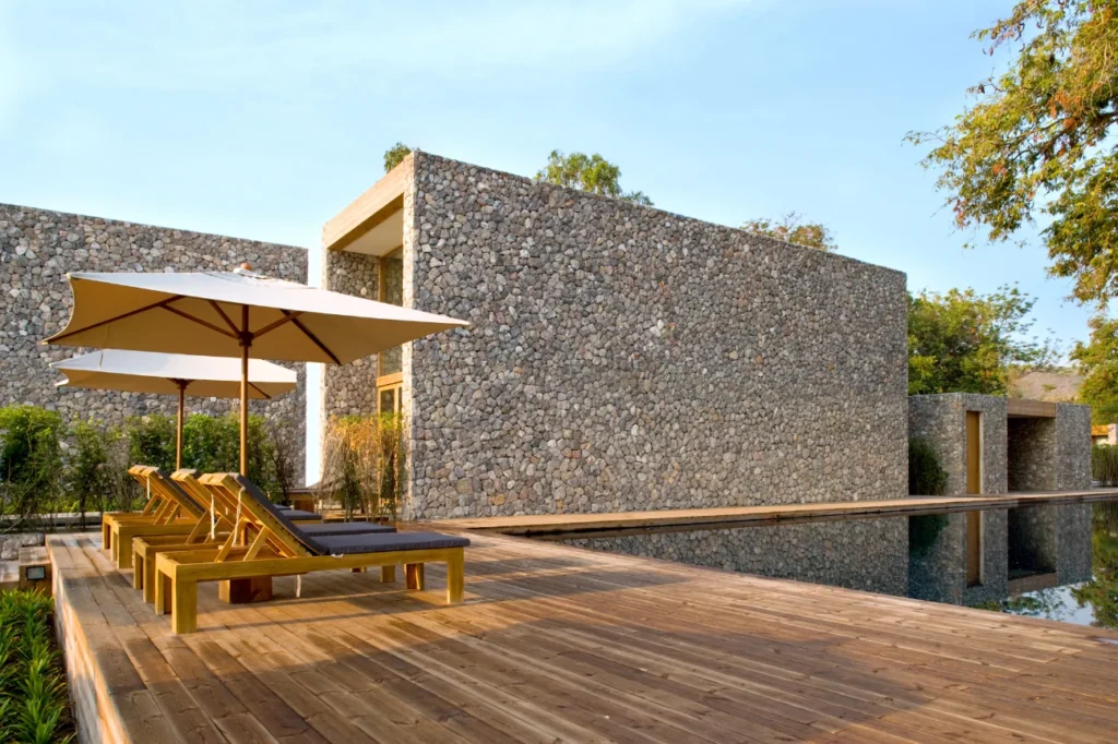 Contemporary deck construction Canterbury by Deck Builders Christchurch with stone architecture and loungers