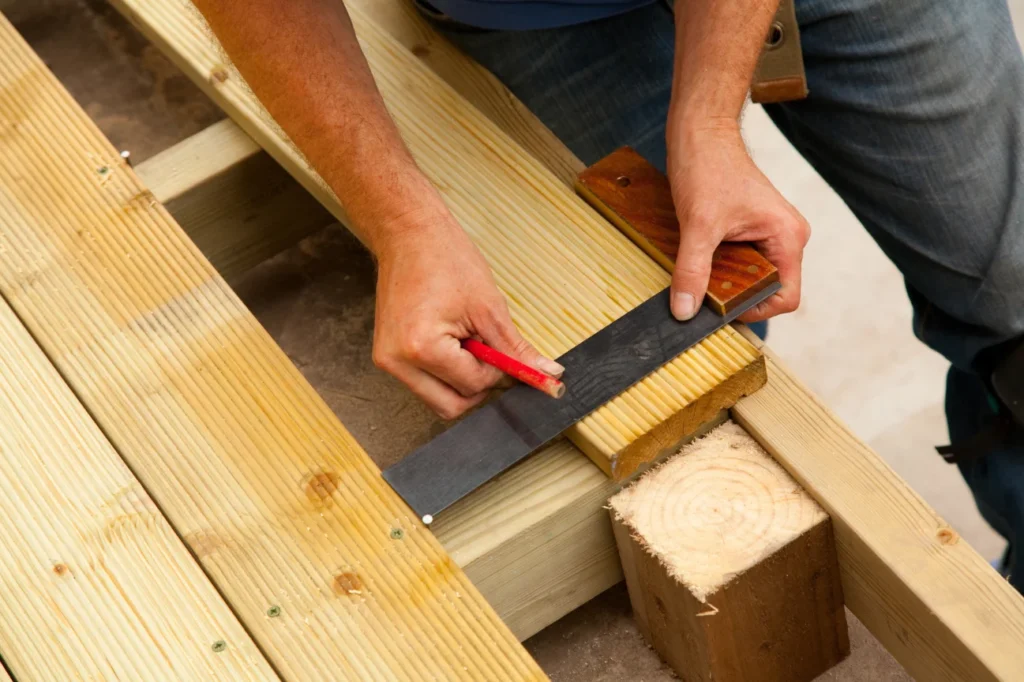 Skilled craftsmanship during deck construction Canterbury by Deck Builders Christchurch with precise timber measuring