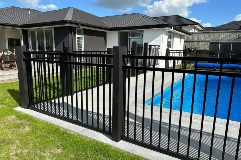 Black metal pool fence built by Fence Builders Christchurch with quality service from Deck Builders Christchurch.